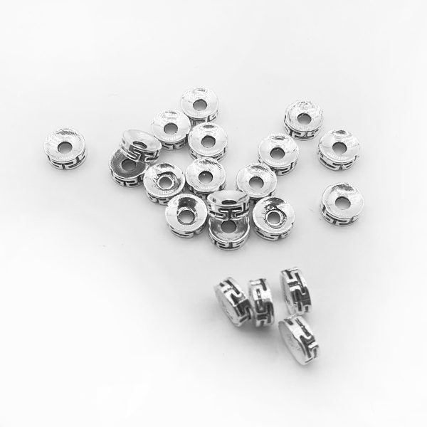 Kovový ozdobný korálek s aztéckékým motivem